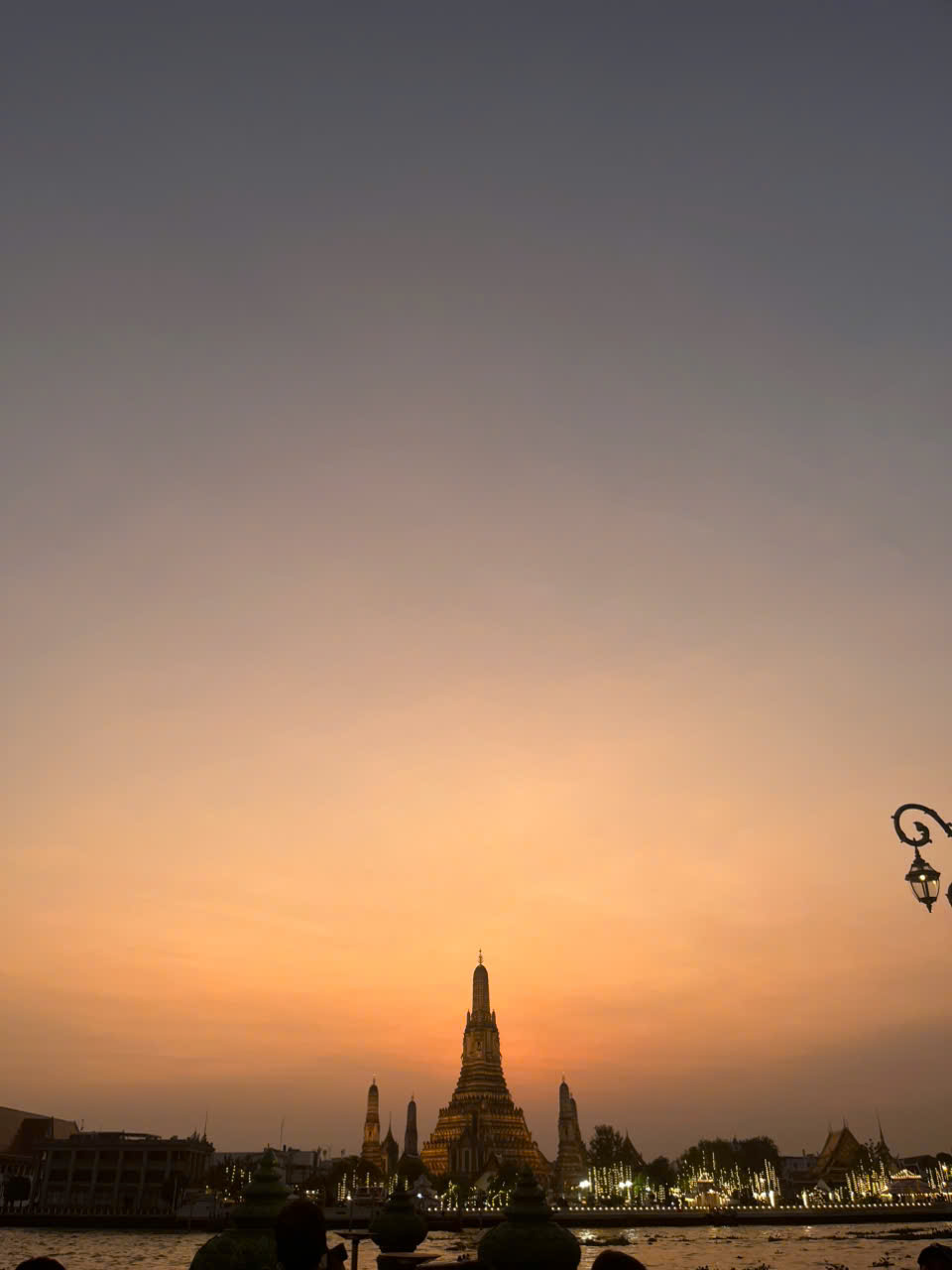 Wat Arun and the Chao Phraya River at sunset in Bangkok